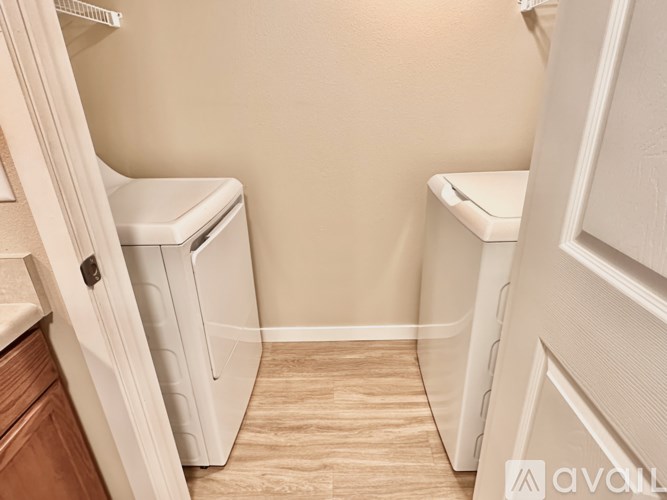 A small bathroom with a toilet and a trash can.