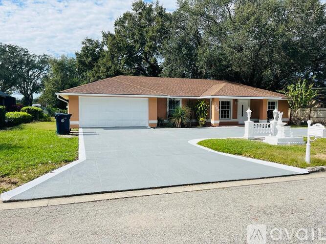 A kitchen with white cabinets and a stainless steel refrigerator.