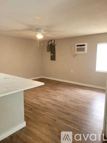 A room with a washing machine and a window with blinds.