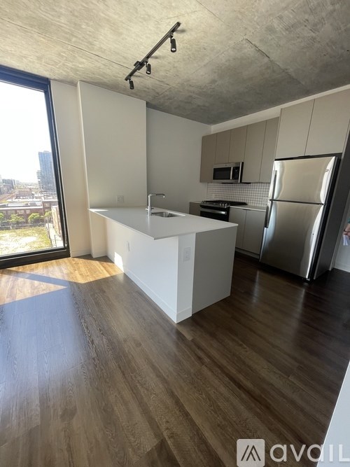 A kitchen with wooden floors and white walls.