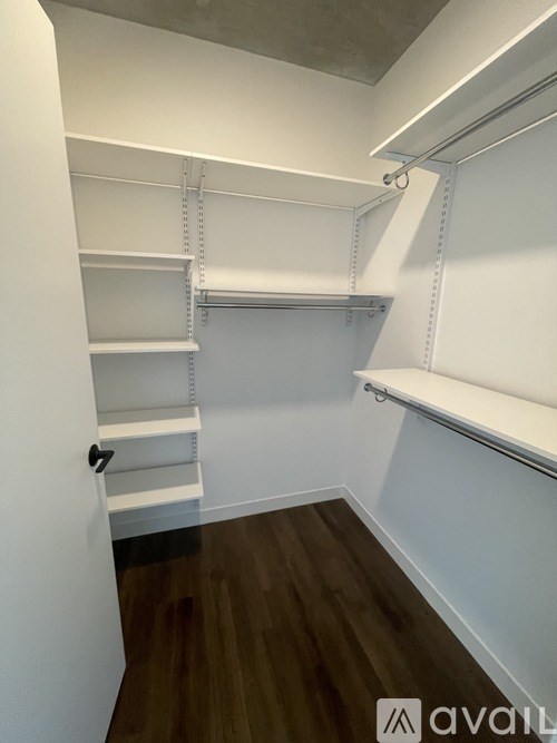Empty white shelves in a room with wood flooring.