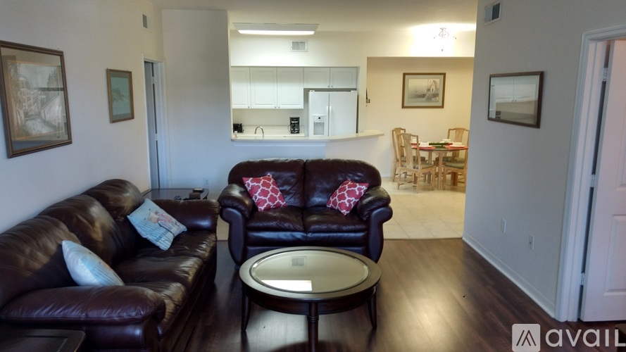 A living room with a brown leather couch and a coffee table.