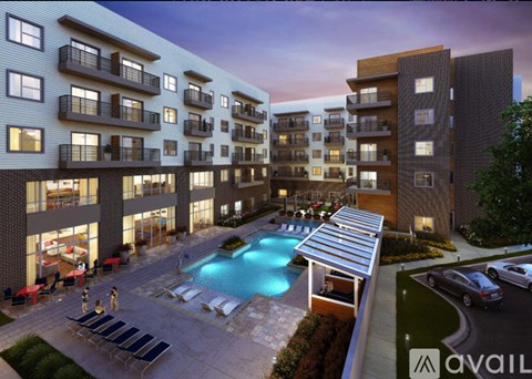 A modern apartment complex with a pool and a sun lounger area.