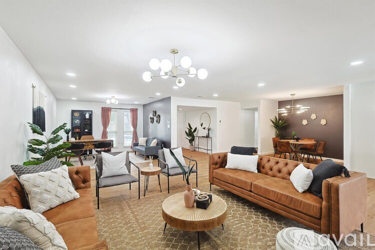 A living room with a brown sofa and a coffee table.