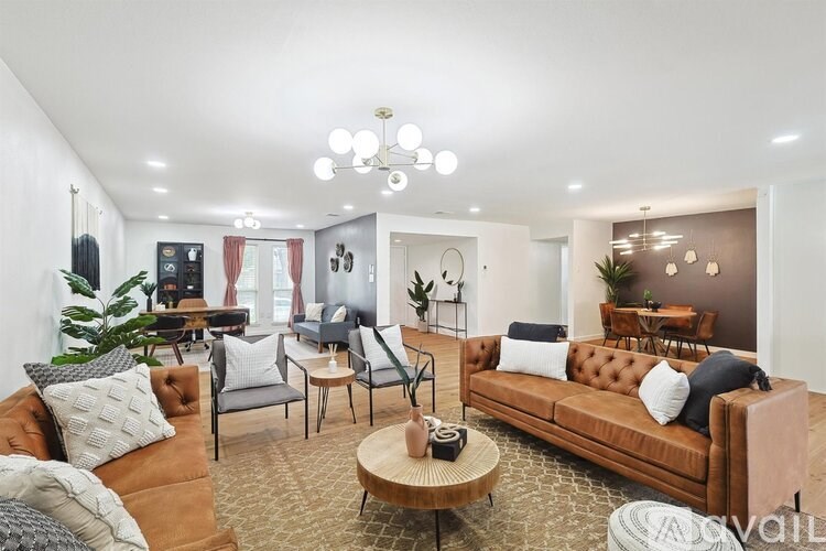 A living room with a brown sofa and a coffee table.