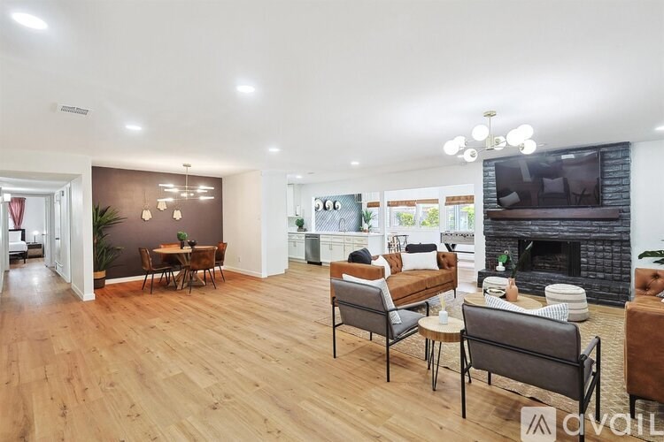 A living room with a fireplace and a television.