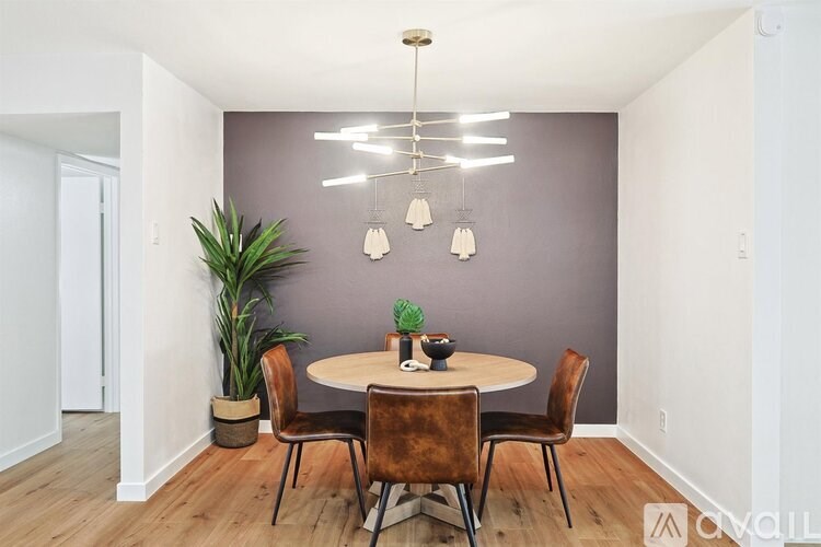 A dining room with a round table and chairs.