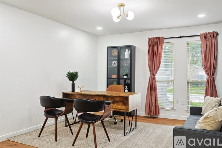 A dining area with a wooden table and chairs.