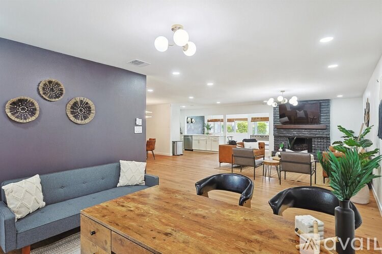 A living room with a grey couch and a wooden coffee table.