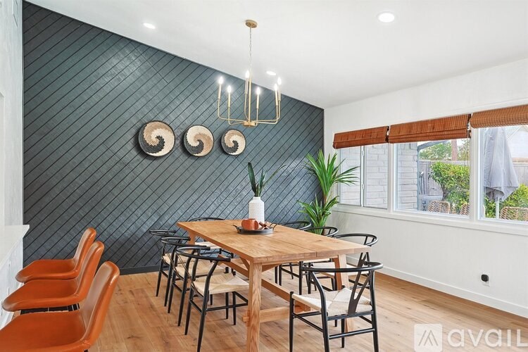 A dining room with a wooden table and chairs.