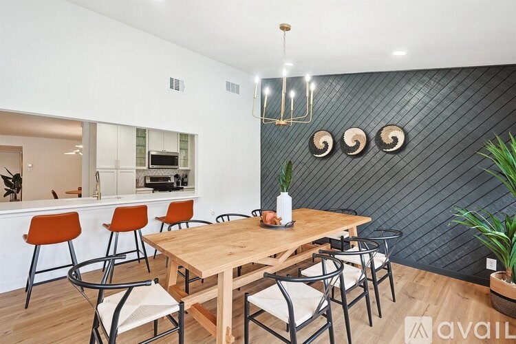 A dining area with a wooden table and chairs.