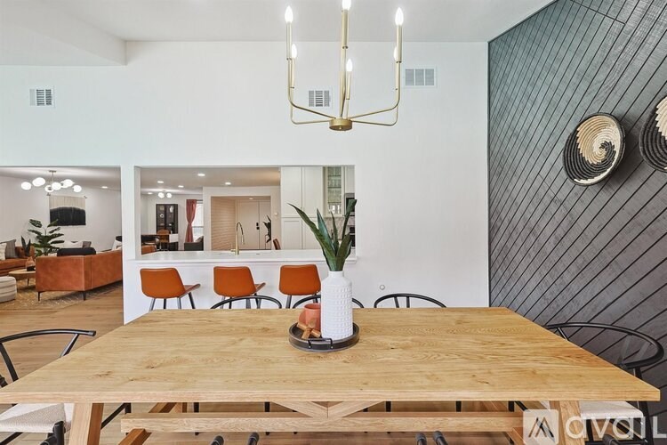 A wooden table with a vase and a plant on it.
