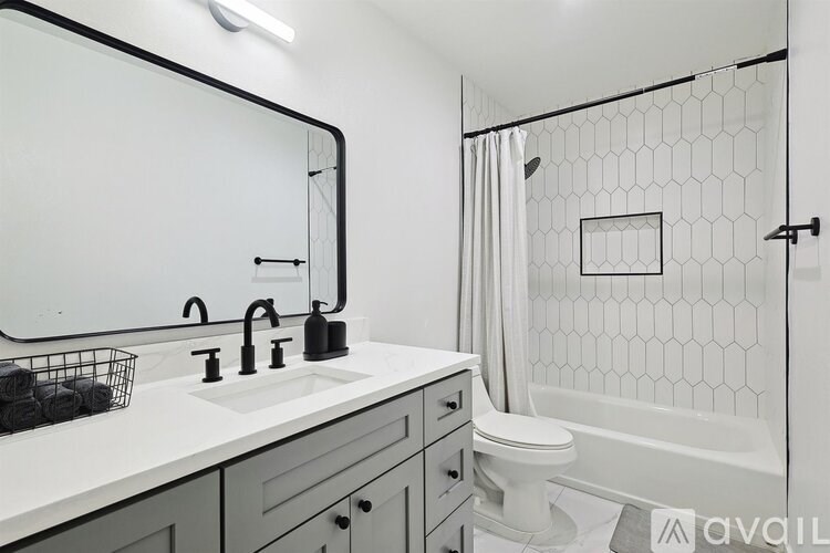 A bathroom with a white sink and a white toilet.