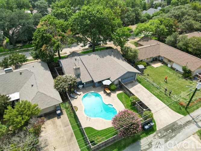 A large backyard with a pool and a deck.