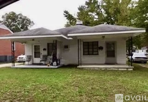 A house with a white front porch and a covered patio area.