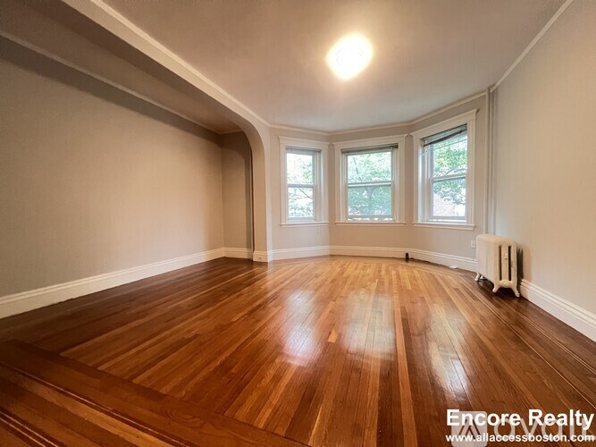 A room with wooden floors and a window.