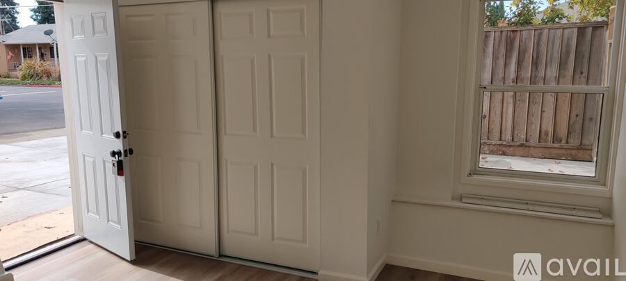 A white door with a black handle is open.