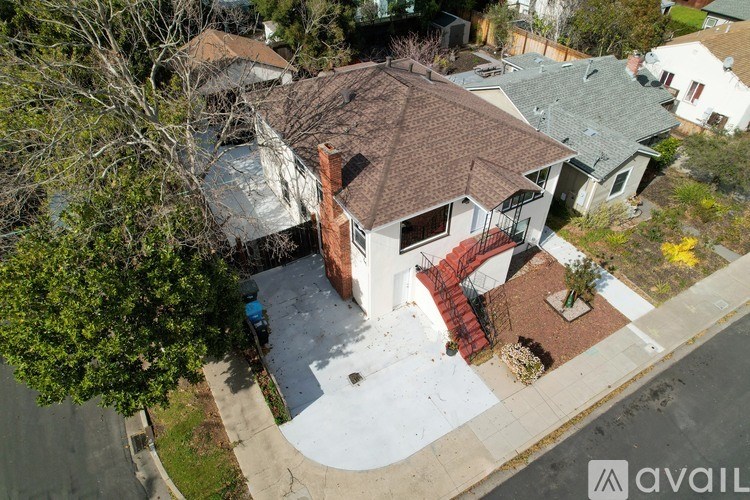 A house with a brown roof and a red staircase.