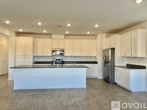 A modern kitchen with white cabinets and a central island.