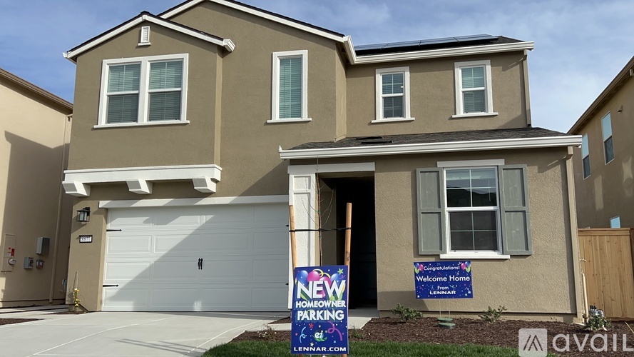 A house with a sign that says New Home Parking.