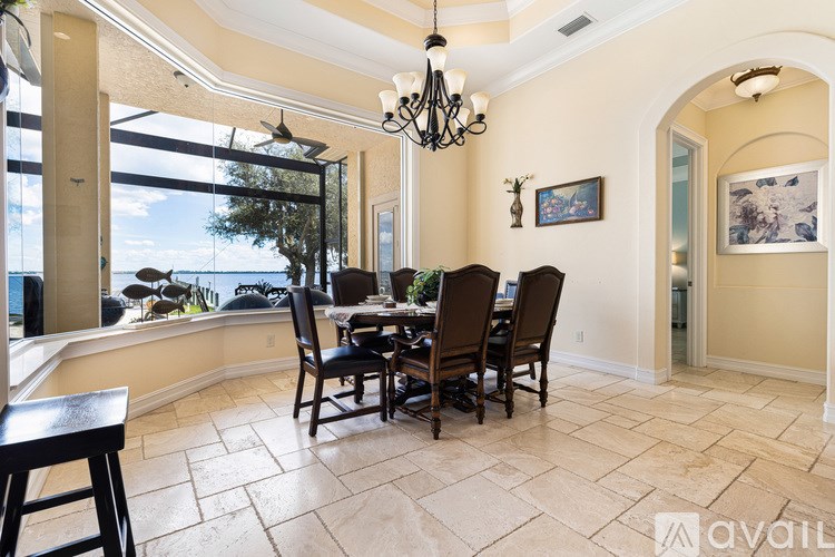 A dining room with a table set for six.