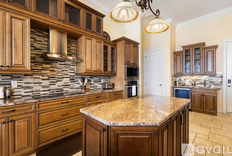 A kitchen with wooden cabinets and granite countertops.