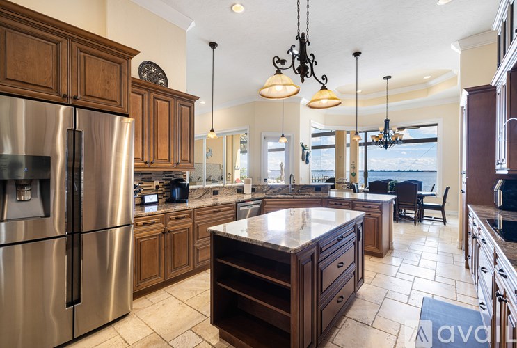 A kitchen with a refrigerator, cabinets, and a countertop.