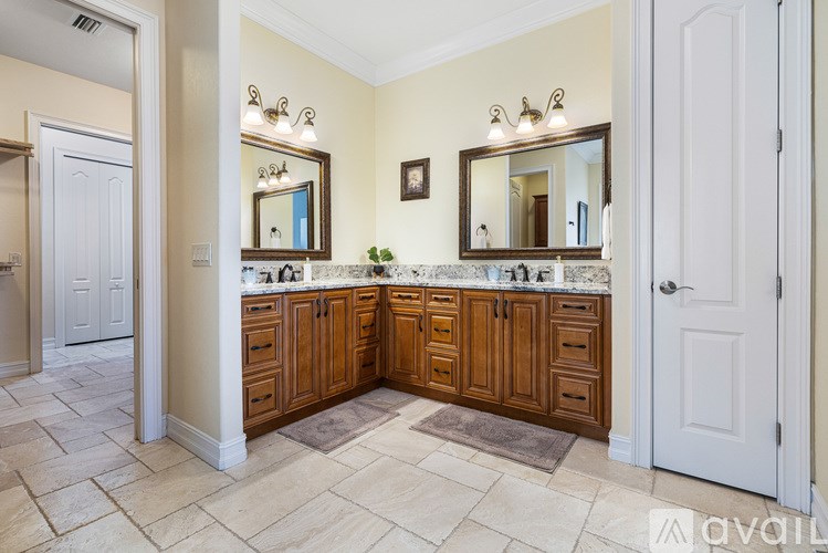 A bathroom with a large vanity and double sinks.