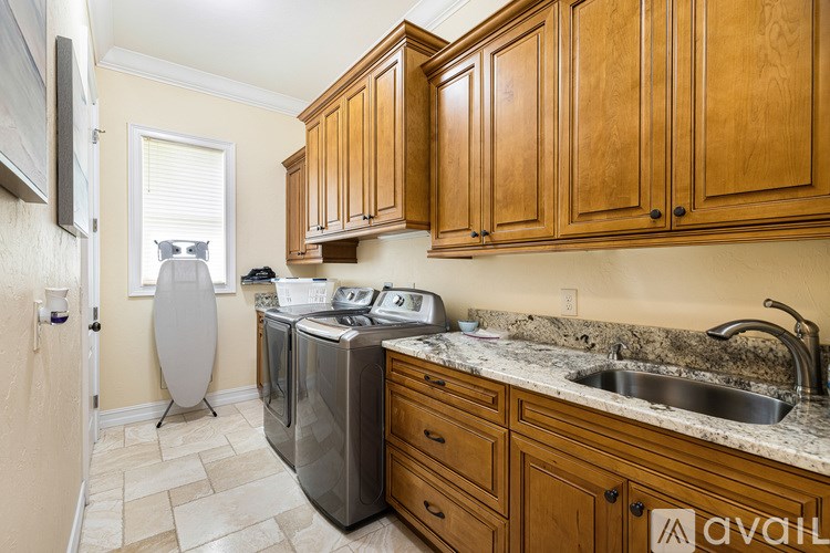 A kitchen with wooden cabinets and a granite counter top.