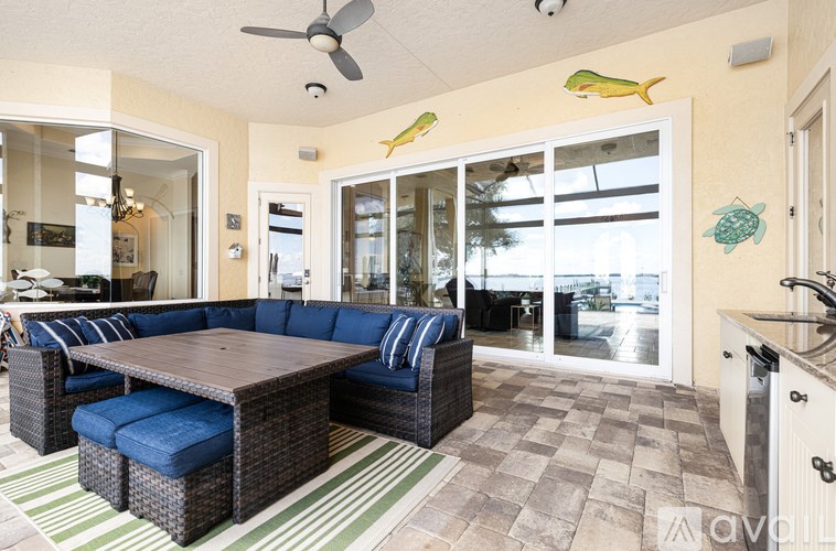 A living room with a blue couch and a wooden table.