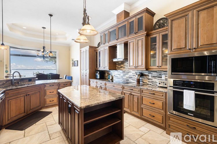 A kitchen with wooden cabinets and a granite countertop.