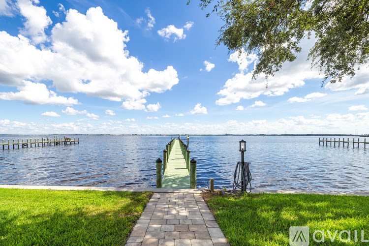 A serene lakeside scene with a dock and a bicycle.