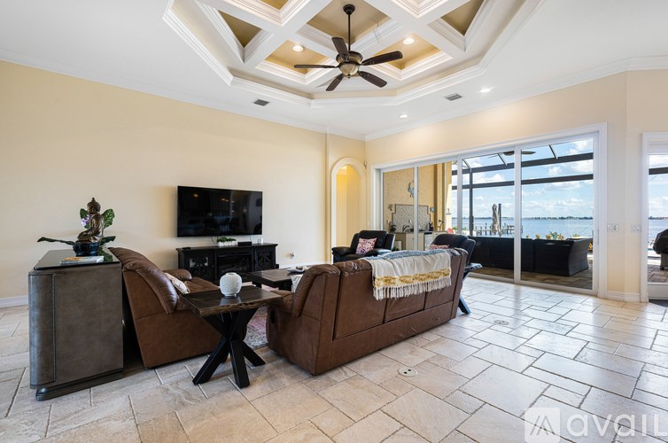 A living room with a brown couch and a black coffee table.