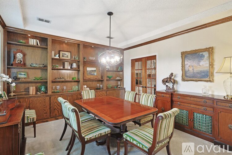 A dining room with a wooden table and chairs.