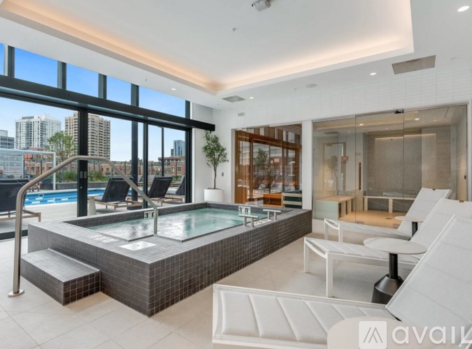 A modern indoor swimming pool with a view of the city.