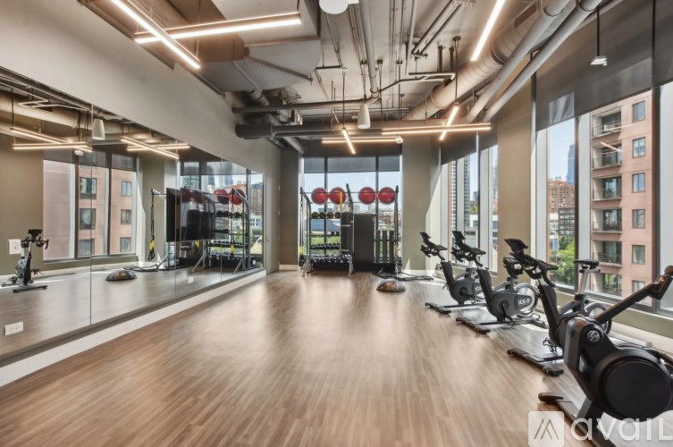 A gym with exercise bikes and a view of the city.