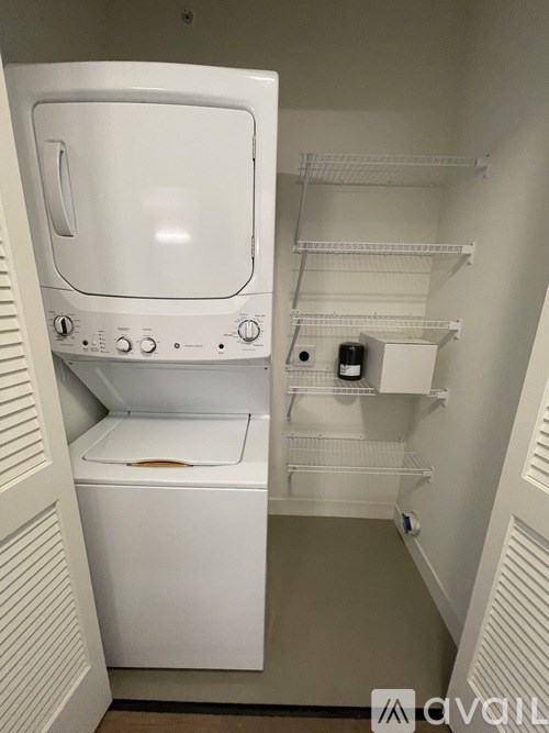 A white dryer and washer in a small laundry room.