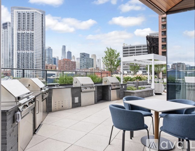 A patio with a table and chairs overlooking a city skyline.