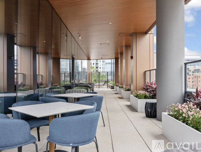 A modern outdoor dining area with tables and chairs.