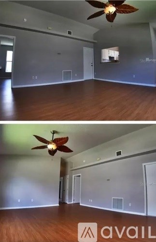 A room with a ceiling fan and wooden floors.