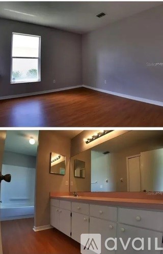 A bathroom with a vanity and a large mirror.