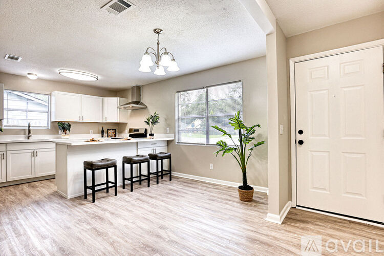 A kitchen with white cabinets and a white counter top.