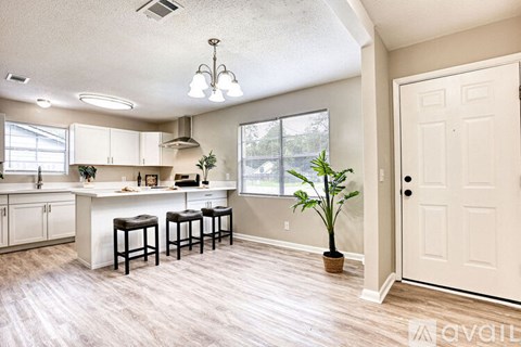 A kitchen with white cabinets and a white counter top.