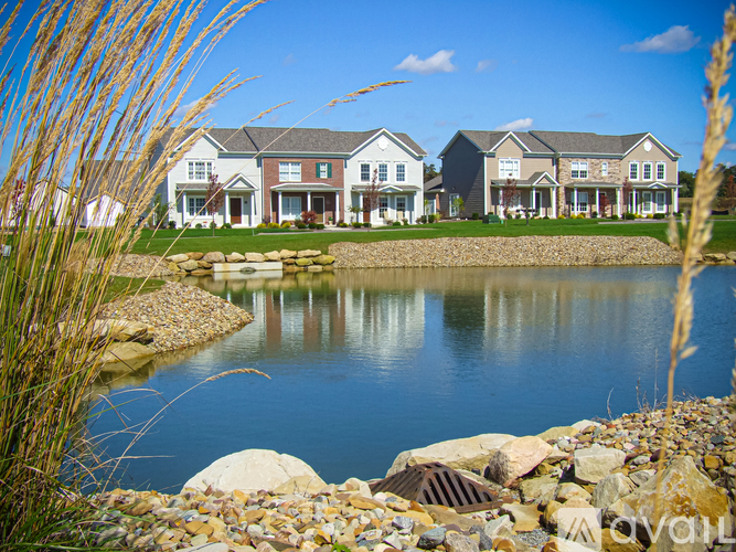 A row of houses with a body of water in front.