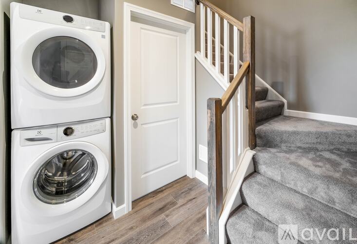 A white washing machine and dryer in a laundry room.