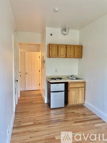 A kitchen with wooden cabinets and a white dishwasher.