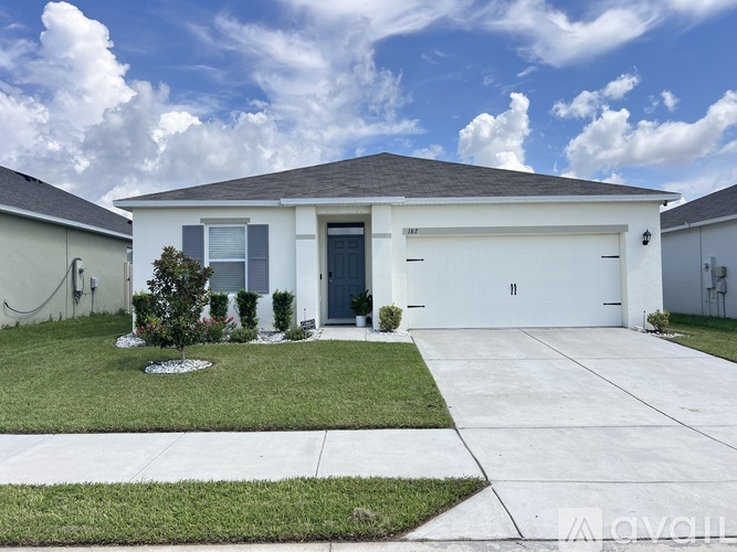A two-story house with a garage and a driveway.
