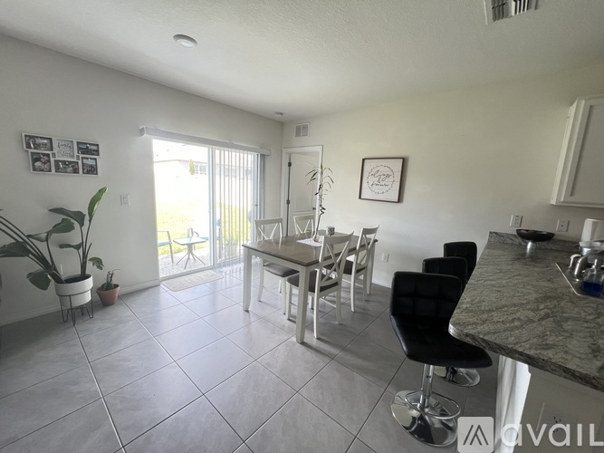 A kitchen with a table and chairs in the middle of the room.