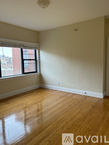 A room with wooden floors and a window.