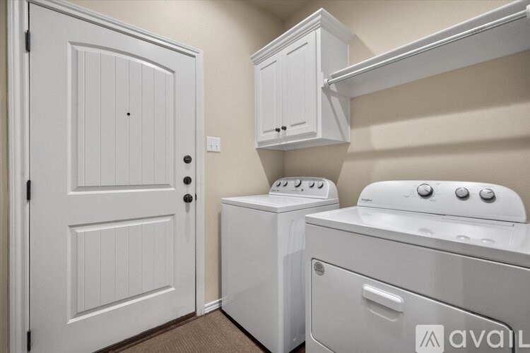 A white door is on the left and a white cabinet is on the right.